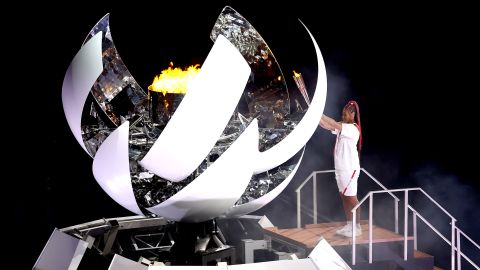 Naomi Osaka of Team Japan lights the Olympic cauldron with the Olympic torch during the Opening Ceremony of the Tokyo 2020 Olympic Games.
