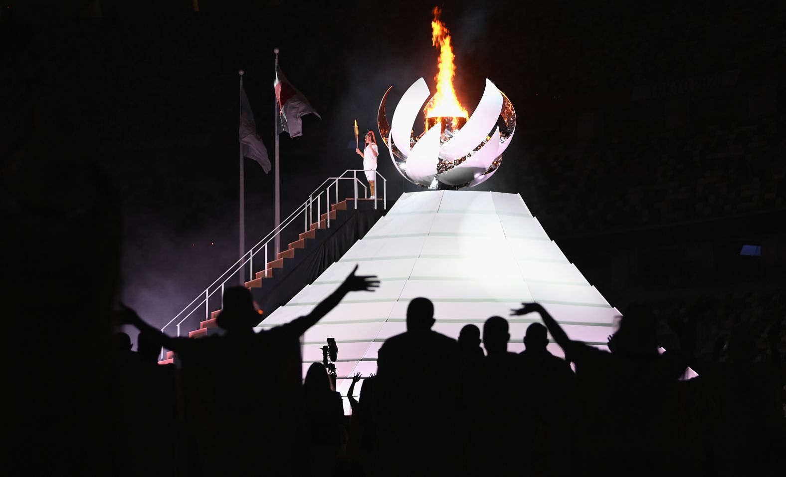 Japanese tennis star Naomi Osaka lights the Olympic cauldron at the end of the opening ceremony on Friday, July 23.