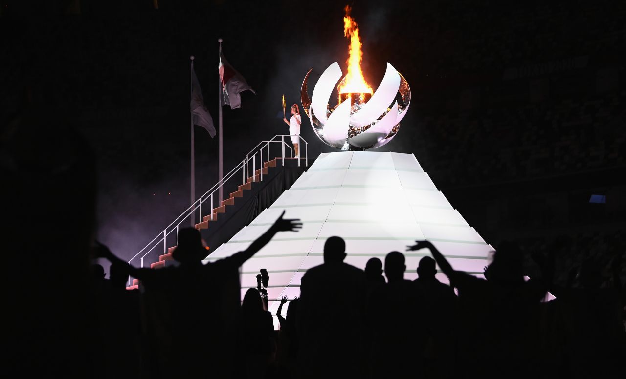 Japanese tennis star Naomi Osaka lights the Olympic cauldron at the end of the opening ceremony on Friday, July 23.