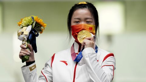 China's Yang Qian celebrates with her gold medal after winning the 10m Air Rifle Women's Final on the first day of the Tokyo 2020 Olympic Games.