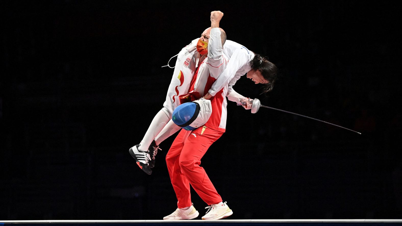 Chinese fencer Sun Yiwen celebrates with her coach Hugues Obry after winning gold in the épée on July 24.