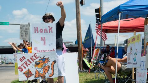 Ron Sadler, employee at Frito-Lay for 32 years, puts his fist up as drivers honk their horns to show support for the union strike Tuesday afternoon, July 20. "I'm way too old to be dealing with this," Sadler said.