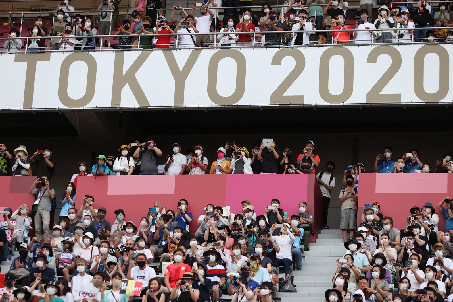 Fans wait at the finish of the men's cycling road race on July 24. The Fuji International Speedway, in Oyama, Japan, is one of the five Olympic venues open to fans this year.