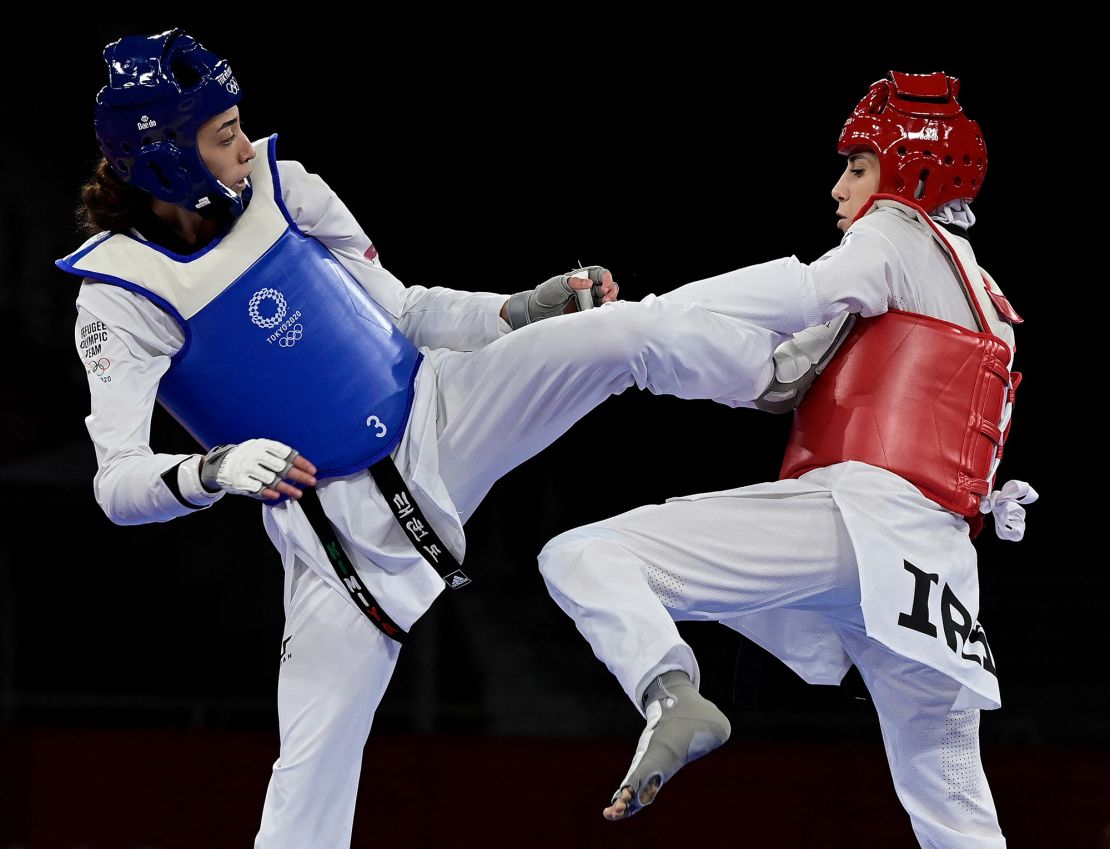 Refugee Olympic Team's Kimia Alizadeh (Blue) and Iran's Nahid Kiyani Chandeh (Red) compete in the taekwondo women's -57kg elimination round bout during the Tokyo 2020 Olympic Games at the Makuhari Messe Hall in Tokyo on July 25, 2021.