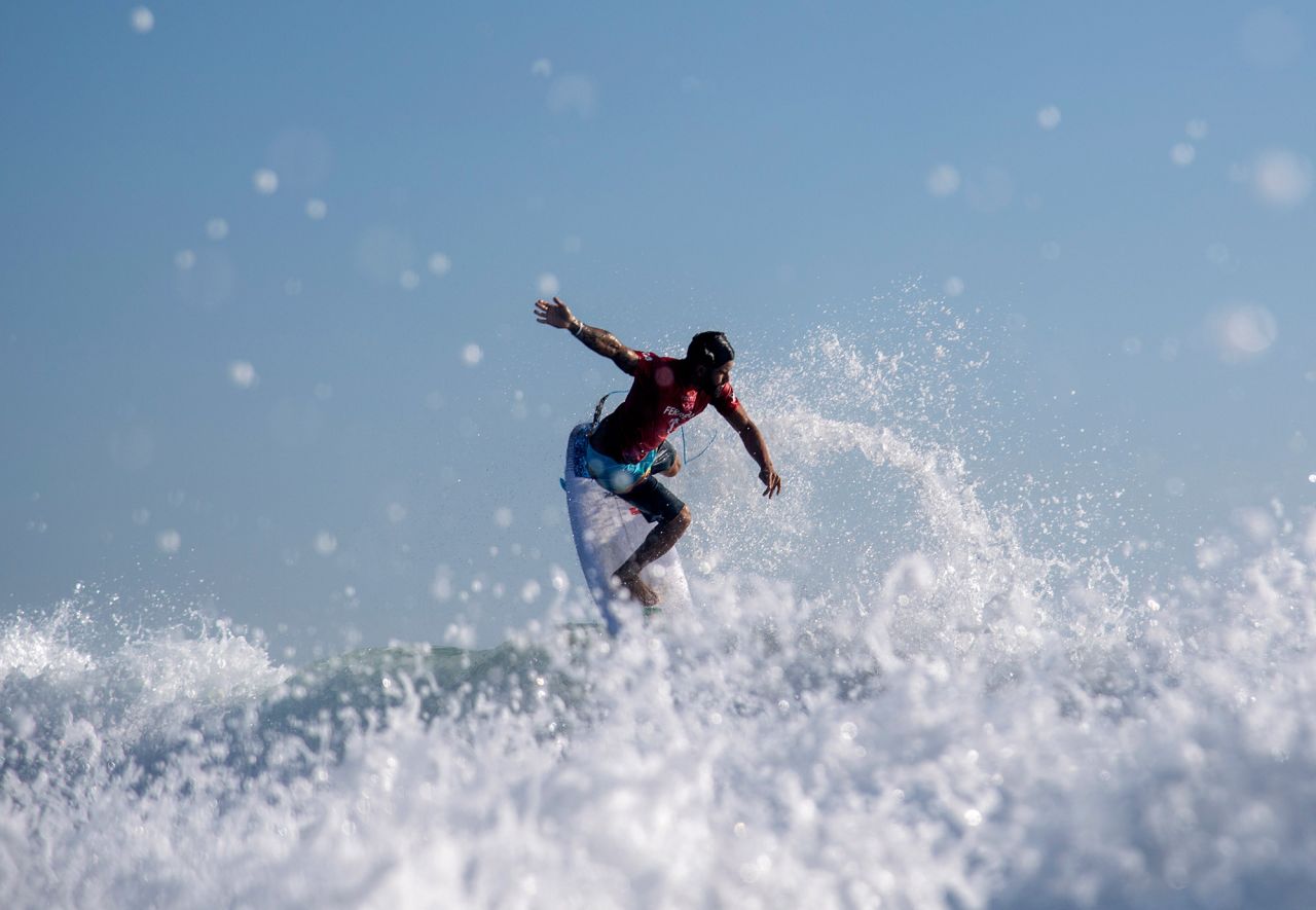 Brazilian surfer Italo Ferreira rides a wave during an early heat on July 25. This is the first year that surfing is in the Olympics.