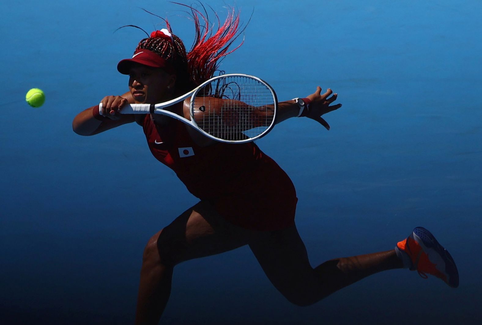 Japan's Naomi Osaka hits a forehand during her first-round match against China's Zheng Saisai on July 25. Osaka won 6-1, 6-4.