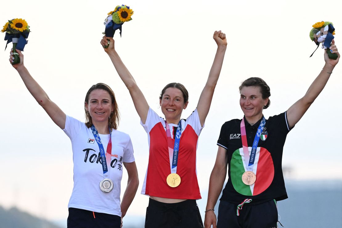 Silver medalist Netherlands' Annemiek Van Vleuten (left), gold medalist Austria's Anna Kiesenhofer (middle) and bronze medalist Italy's Elisa Longo Borghini (right) celebrate on the podium during the women's road race medal ceremony. 
