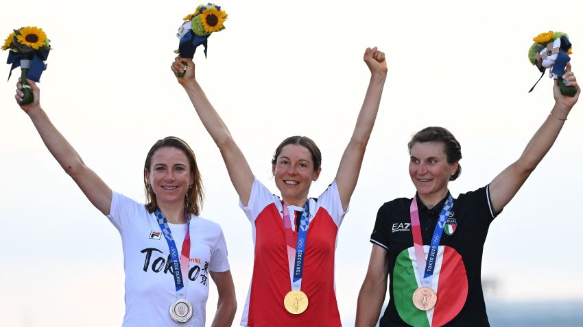 (L-R) Silver medallist Netherlands' Annemiek Van Vleuten, Gold medallist Austria's Anna Kiesenhofer and bronze medallist Italy's Elisa Longo Borghini celebrate on the podium during the medal ceremony for the women's cycling road race of the Tokyo 2020 Olympic Games, at the Fuji International Speedway in Oyama, Japan, on July 25, 2021.