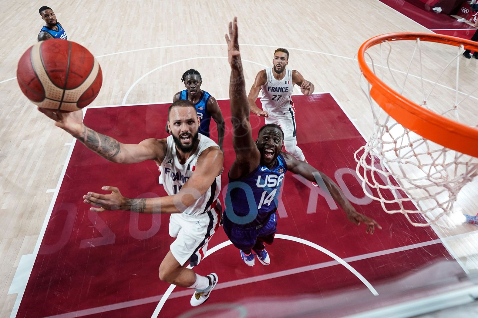 The Tokyo 2020 logo is reflected in the backboard as France's Evan Fournier rises for a shot on July 25. <a href="index.php?page=&url=https%3A%2F%2Fwww.cnn.com%2Fworld%2Flive-news%2Ftokyo-2020-olympics-07-25-21-spt%2Fh_a157087079778afeb7aea72e8d599708" target="_blank">France upset the United States</a> 83-76 in what was both teams' opening games. The US team hadn't lost an Olympic game since 2004.