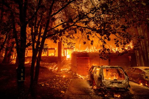 Flames consume a home as the Dixie Fire tears through the Indian Falls community of Plumas County, California, on July 24.