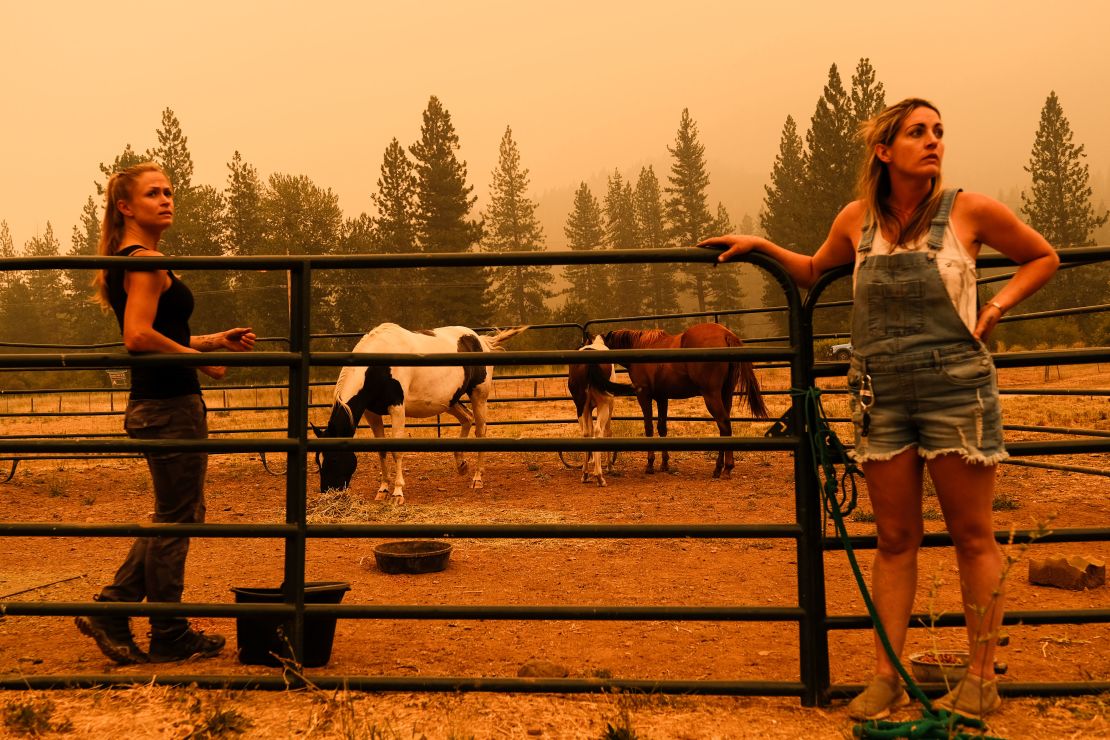 Residents wait for a trailer to evacuate horses at a ranch in Crescent Mills on July 24.