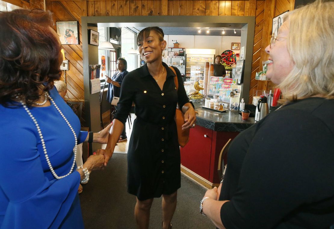 Shontel Brown, candidate for Ohio's 11th District, greets Akron city council members Ginger Baylor, at-large, and Nancy Holland, Ward 1 at Angel Falls Coffee shop in Akron on July 14, 2021.