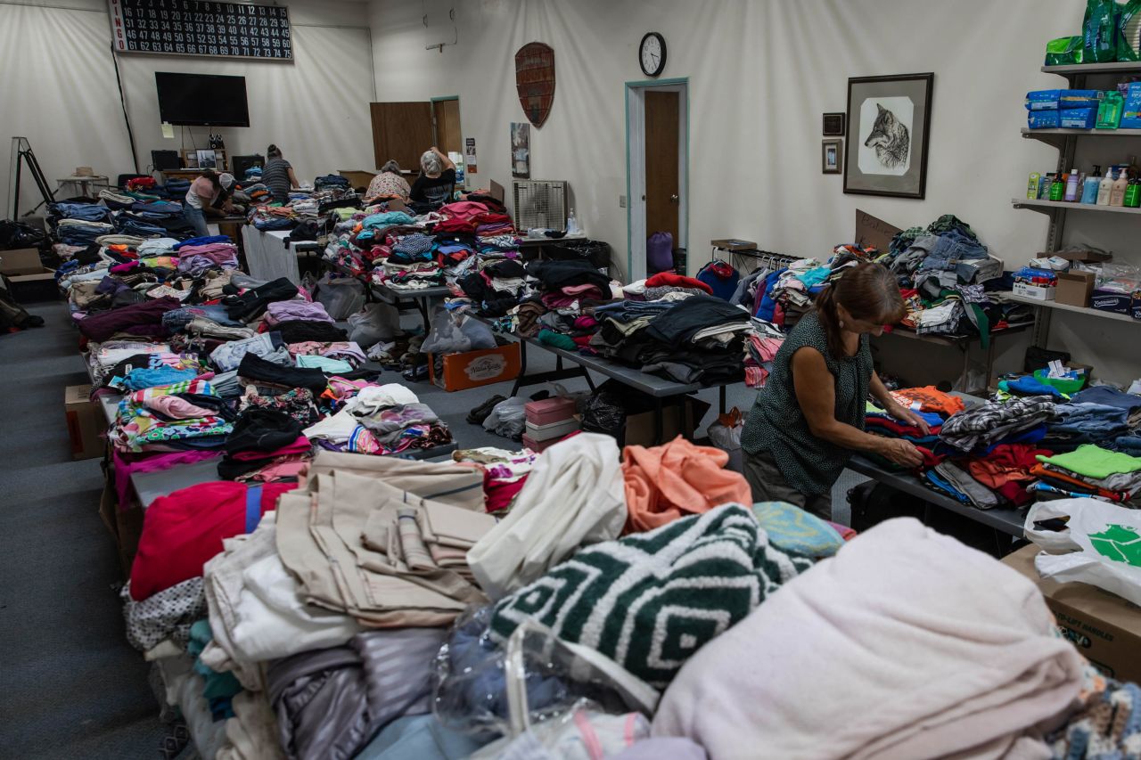 Volunteers sort clothing at a donation shelter for those affected by the Bootleg Fire in Bly, Oregon.