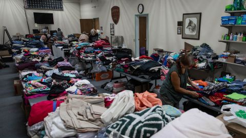 Volunteers sort clothing at a donation shelter for those affected by the Bootleg Fire in Bly, Oregon.