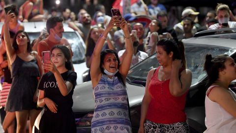 People celebrate in the street after Tunisian President Kais Saied announced the dissolution of parliament and Prime Minister Hichem Mechichi's government in Tunis on July 25, 2021.