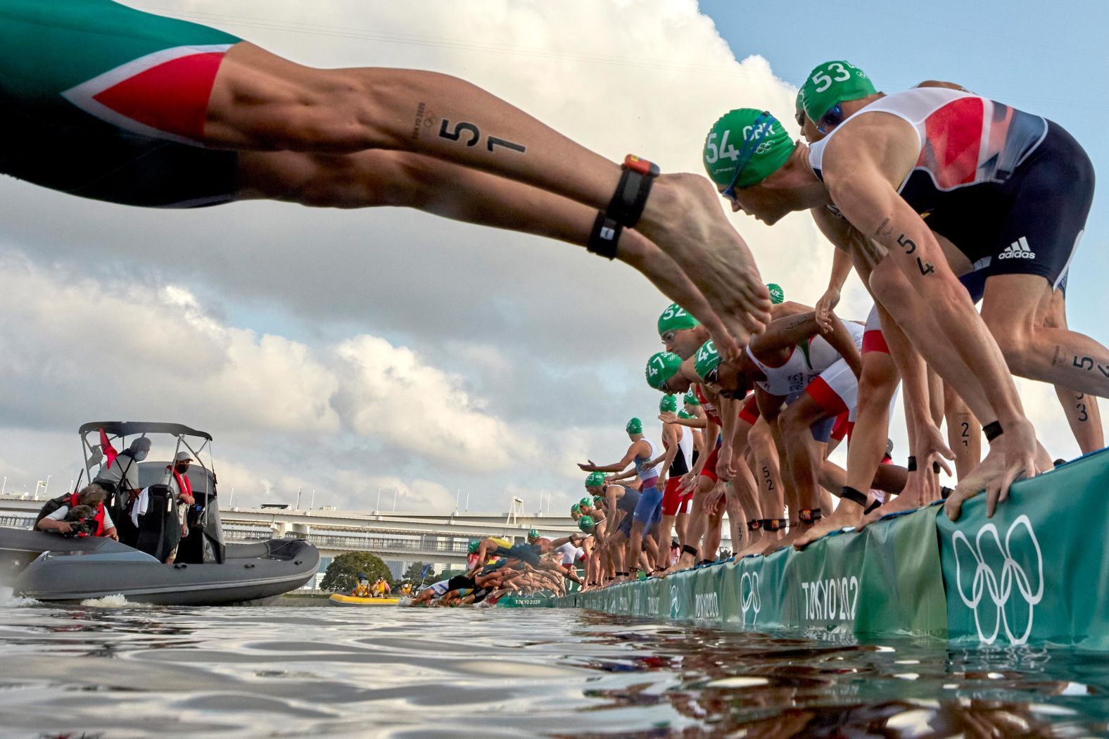 Athletes dive into the water at the start of the men's triathlon on July 26. A broadcast boat prevented all swimmers from starting, <a href="index.php?page=&url=https%3A%2F%2Fwww.nbcolympics.com%2Fnews%2Fmens-triathlon-kicks-bizarre-false-start-first-olympic-history" target="_blank" target="_blank">forcing a restart.</a> It was the first-ever call of its kind in an Olympic triathlon.