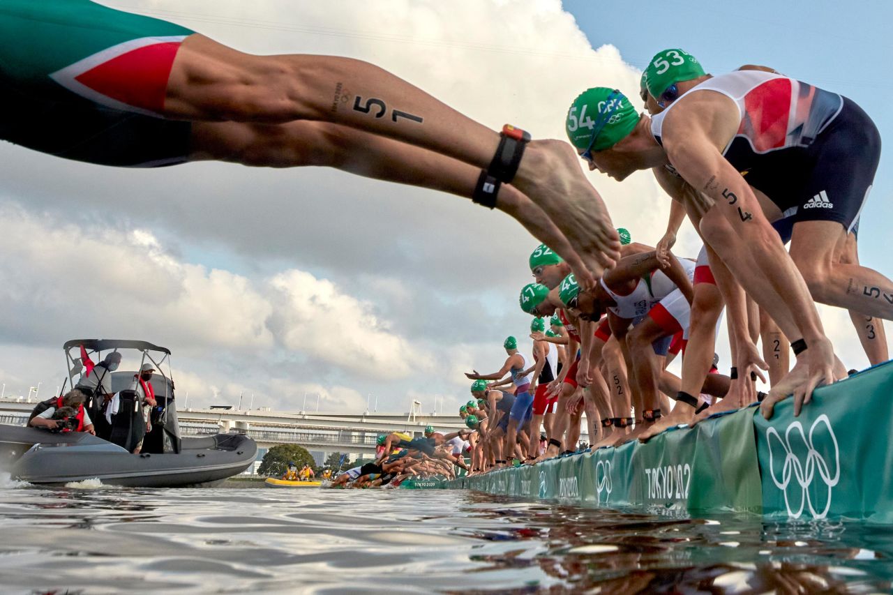 Athletes dive into the water at the start of the men's triathlon on July 26. A broadcast boat prevented all swimmers from starting, <a href="https://www.nbcolympics.com/news/mens-triathlon-kicks-bizarre-false-start-first-olympic-history" target="_blank" target="_blank">forcing a restart.</a> It was the first-ever call of its kind in an Olympic triathlon.