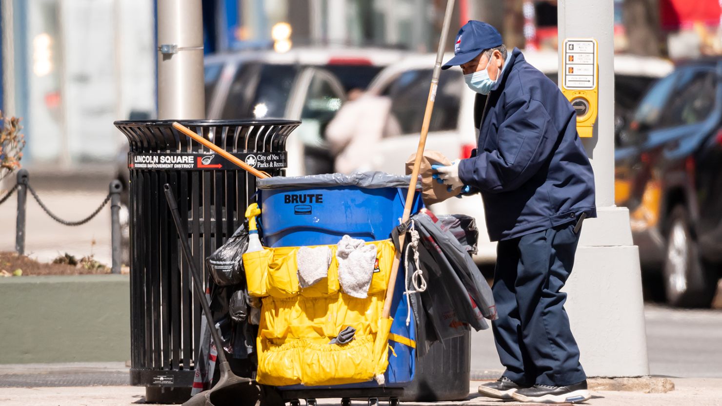 A sanitation worker cleans the street on the Upper West Side amid the coronavirus pandemic on March 30, 2021, in New York City. 