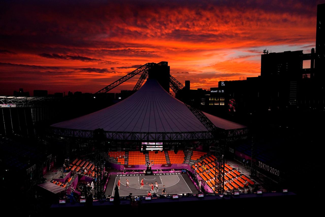 The sun sets in Tokyo on July 26 as Belgium plays the Netherlands in a men's 3-on-3 basketball game. The event is making its Olympic debut this year.