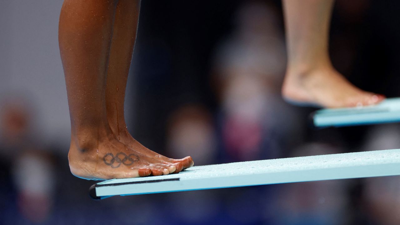 The classic Olympic rings tattoo is seen on Canada's Jennifer Abel's foot, as she prepares to compete in the women's synchronised 3m springboard diving final event on July 25, 2021.