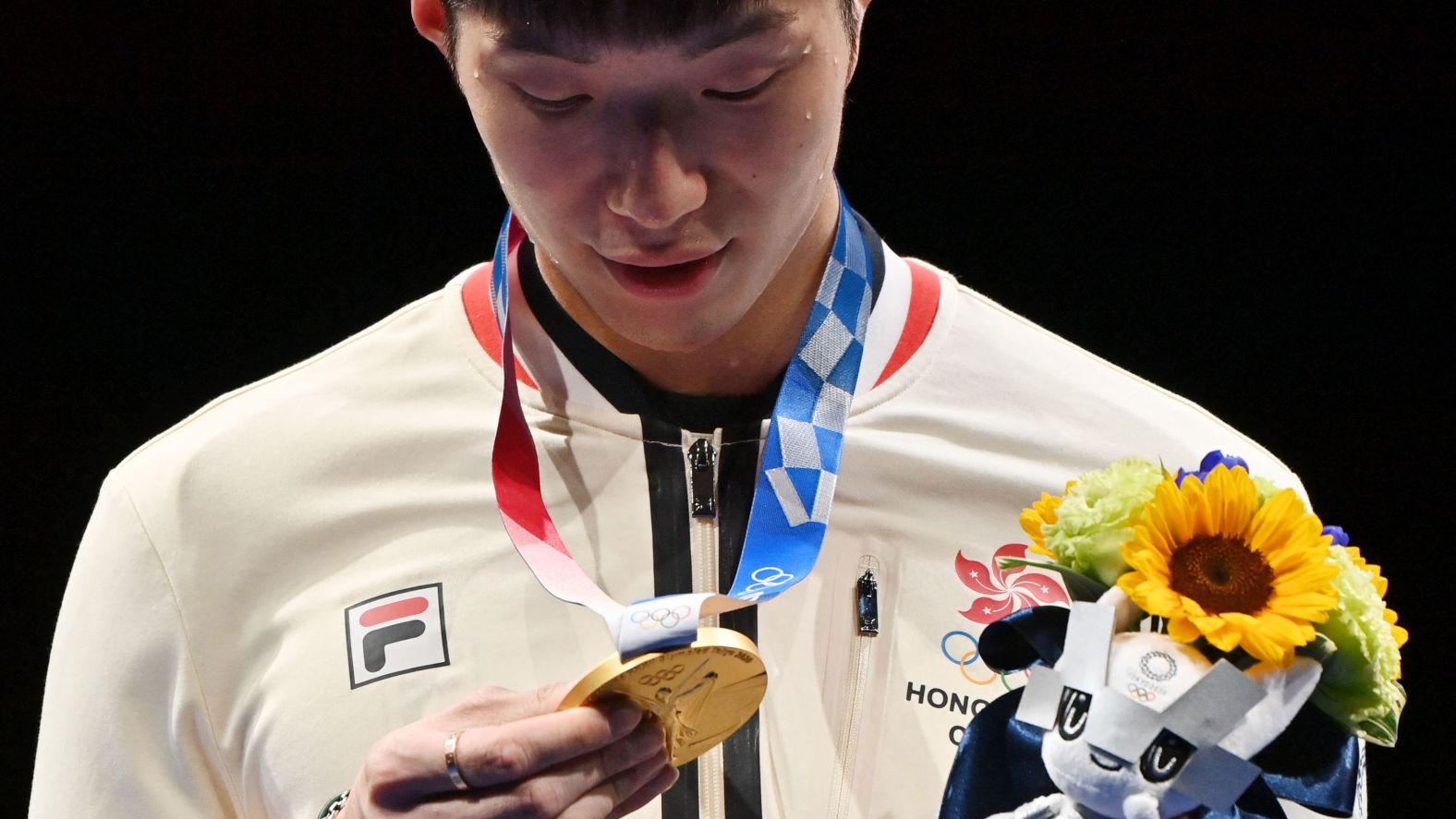 Hong Kong fencer Edgar Cheung looks at his gold medal after beating Italy's Daniele Garozzo in the men's foil final on July 26. It was <a href="https://www.cnn.com/world/live-news/tokyo-2020-olympics-07-26-21-spt/h_49e87856e0c333e6f009a513d4e01e57" target="_blank">Hong Kong's first gold</a> at the Summer Olympics in 25 years.