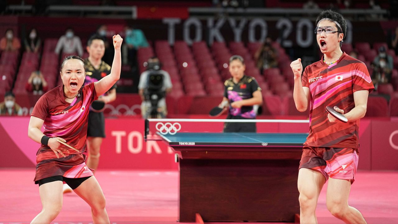 Mizutani Jun and Mima Ito of Japan cheer during the table tennis mixed doubles final against China on July 26.