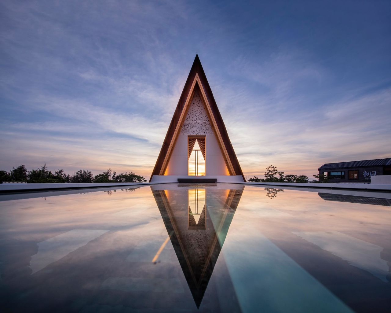 Designed by Shanghai United Design Group, this triangular structure sits in a pool of water above the Dysis Church of Poly Shallow Sea, in the Chinese seaside city of Sanya.