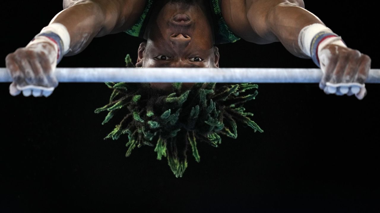 Uche Eke, of Nigeria, competes on the horizontal bar during the men's artistic gymnastic qualifications at the 2020 Summer Olympics, Saturday, July 24, 2021, in Tokyo, Japan. (AP Photo/Gregory Bull)