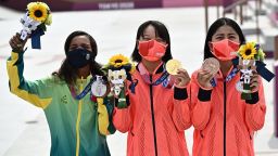 (LtoR) Brazil's Rayssa Leal (silver), Japan's Momiji Nishiya (gold) and Japan's Funa Nakayama (bronze) pose during the medal ceremony of the podium ceremony of the skateboarding women's street final of the Tokyo 2020 Olympic Games at Ariake Sports Park in Tokyo on July 26, 2021. (Photo by Jeff PACHOUD / AFP) (Photo by JEFF PACHOUD/AFP via Getty Images)