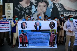 In this June 25, 2021, photo, former Afghan interpreters hold placards during a demonstrations against the US government, in front of the US Embassy in Kabul, Afghanistan. The Biden administration says it will evacuate about 2,500 Afghans who worked for the US government and their families to a military base in Virginia pending approval of their visas. 