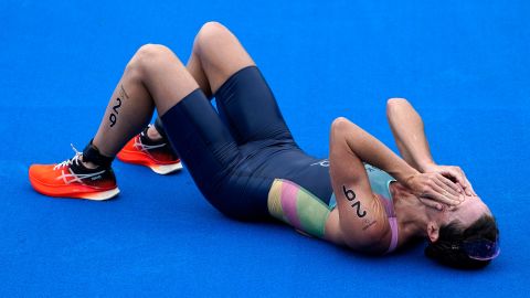 Flora Duffy of Bermuda celebrates after crossing the finish line to win the gold medal in the women's individual triathlon at 2020 Summer Olympics.
