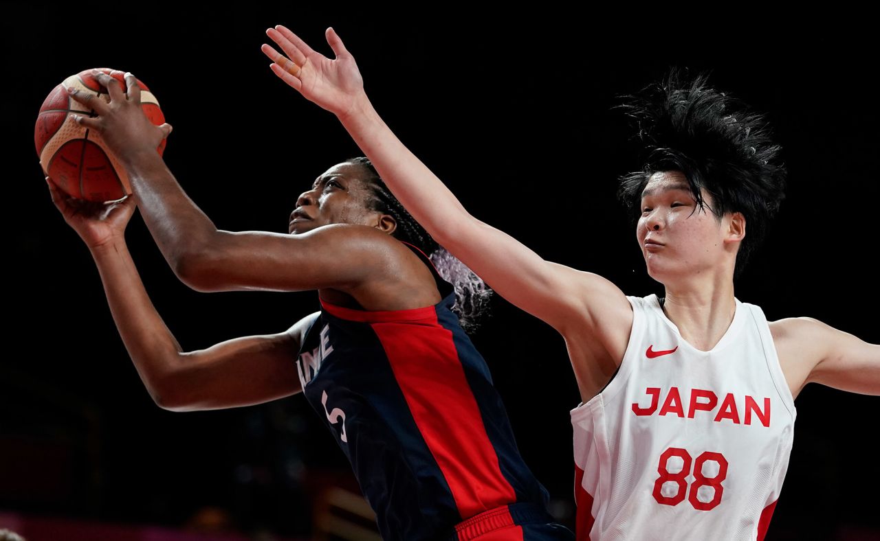 France's Endy Miyem is defended by Japan's Himawari Akaho during a basketball game on July 27. Japan defeated France 74-70.