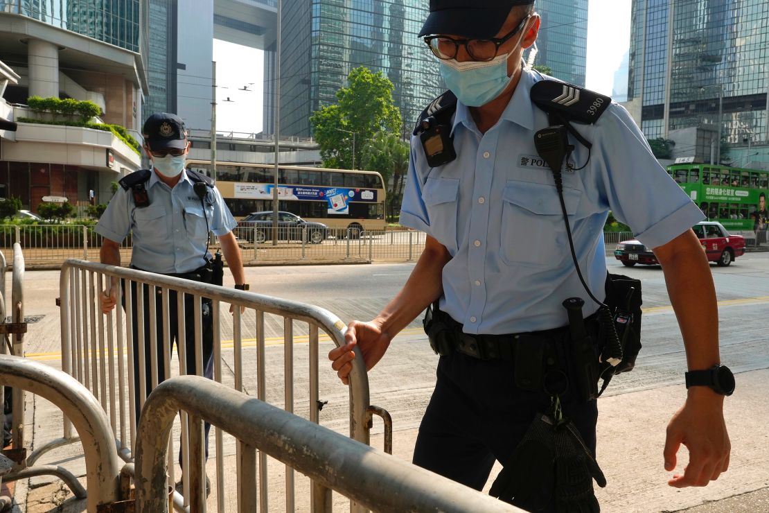 Police officers set up barriers ahead of Tong Ying-kit's arrival in court in Hong Kong on July 27.