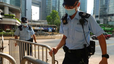 Police officers set up barriers ahead of Tong Ying-kit's arrival in court in Hong Kong on July 27.