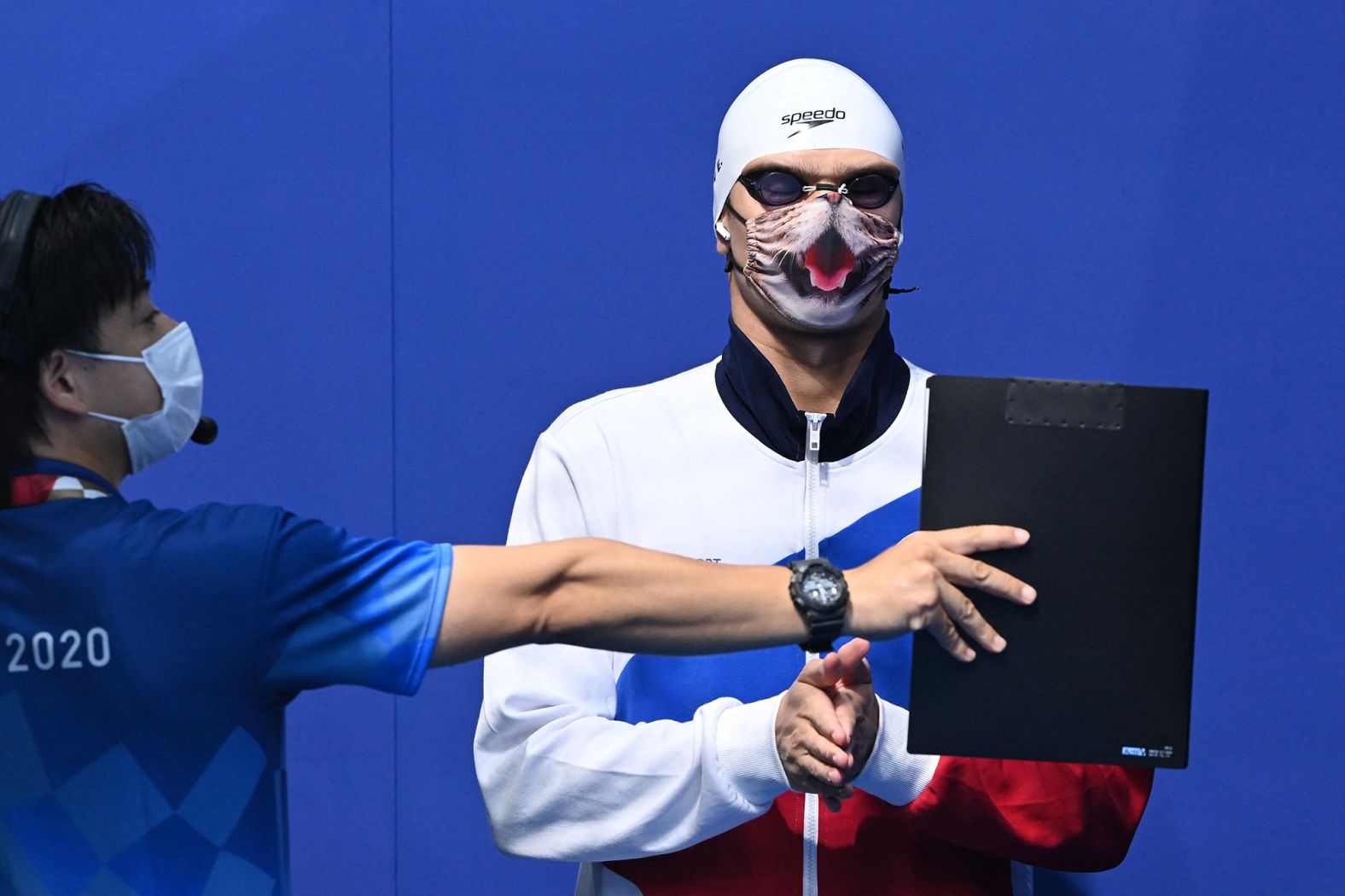Russian swimmer Evgeny Rylov wears a cat-themed mask as he waits to receive his gold medal on July 27. <a href="https://www.cnn.com/world/live-news/tokyo-2020-olympics-07-26-21-spt/h_ca80c586169141bbb5c36a560e96b1cf" target="_blank">Rylov won the 100-meter backstroke.</a>