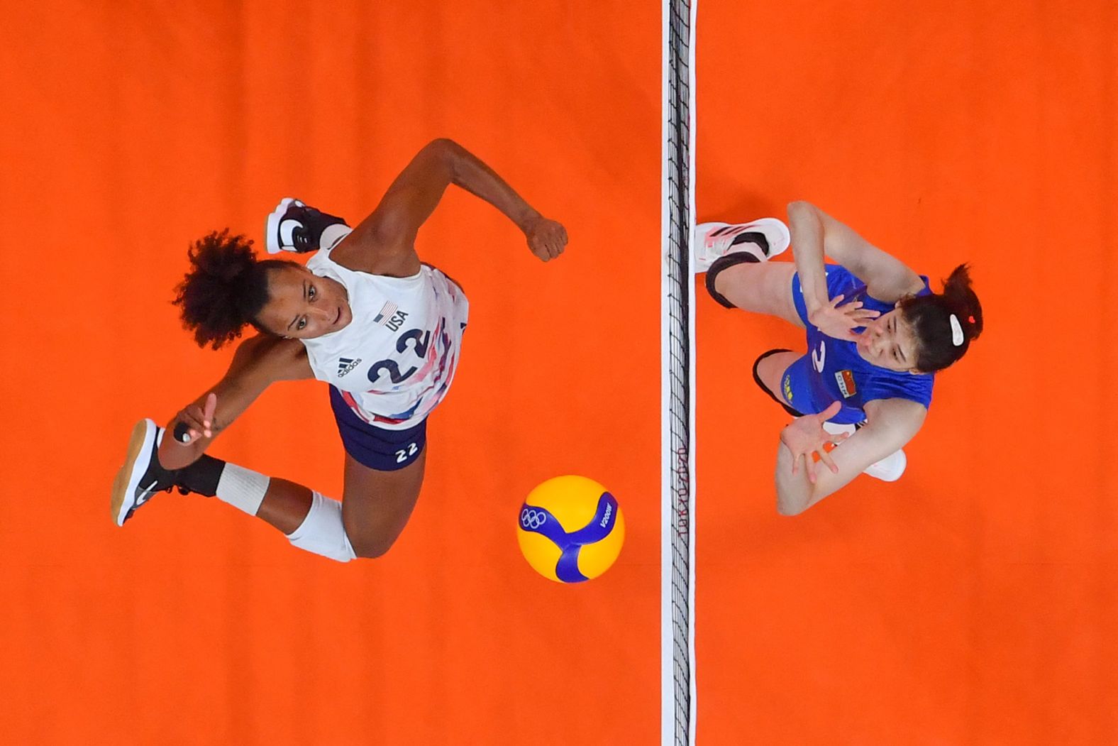 American Haleigh Washington, left, spikes the ball during a volleyball match against China on July 27. The United States won in straight sets, 29-27, 25-22, 25-21.