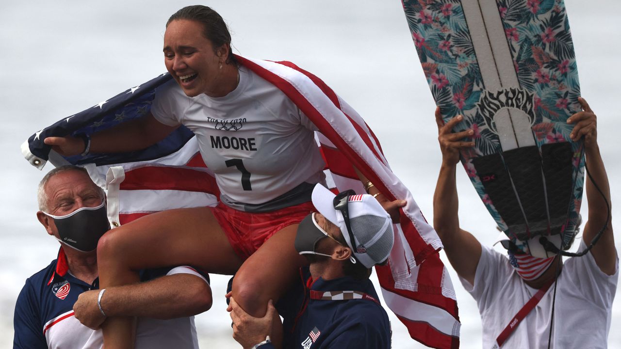 US's Carissa Moore celebrates after winning the women's Surfing gold medal final at the Tsurigasaki Surfing Beach, in Chiba, on July 27, 2021, during the Tokyo 2020 Olympic Games.