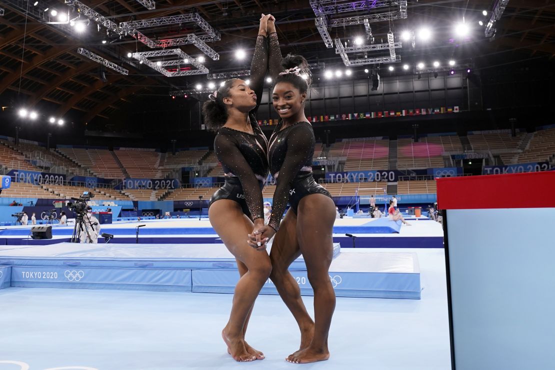 Simone Biles, of the United States, right, poses for pictures with teammate Jordan Chiles after an artistic gymnastics practice session at the 2020 Summer Olympics in Tokyo.
