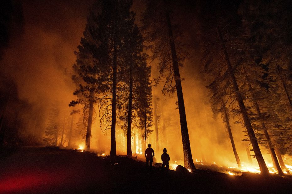 Cal Fire Capts. Tristan Gale, left, and Derek Leong monitor a firing operation in California's Lassen National Forest on July 26. Crews had set a ground fire to stop the Dixie Fire from spreading.