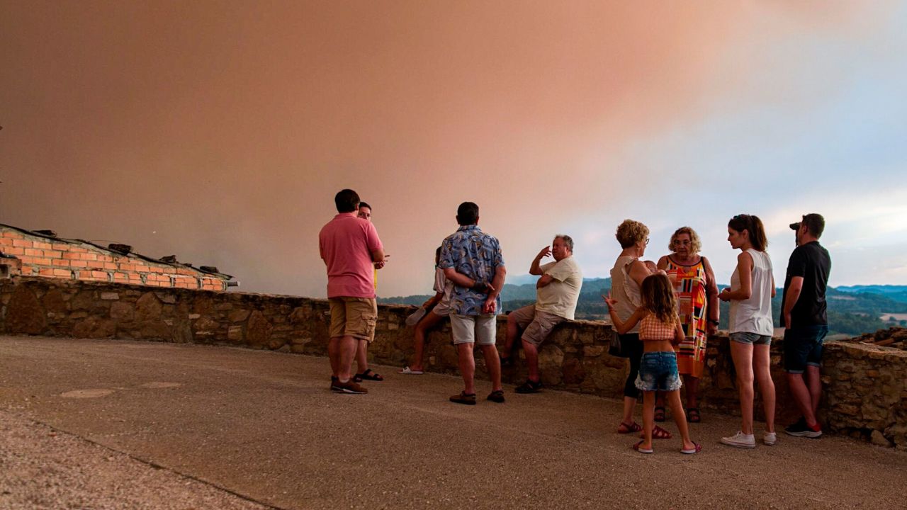 Locals watch fires spread in Sant Martí de Tous, Catalonia.