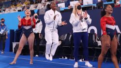 TOKYO, JAPAN - JULY 27: Sunisa Lee, Simone Biles, coach Cecile Landi and Jordan Chiles of Team United States cheer as Grace McCallum (not pictured) competes in floor routine during the Women's Team Final on day four of the Tokyo 2020 Olympic Games at Ariake Gymnastics Centre on July 27, 2021 in Tokyo, Japan. (Photo by Laurence Griffiths/Getty Images)