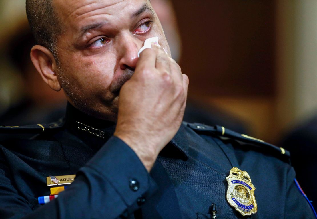 U.S. Capitol Police Sgt. Aquilino Gonell wipes his eye as he watches a video being displayed during a House select committee hearing Tuesday.
