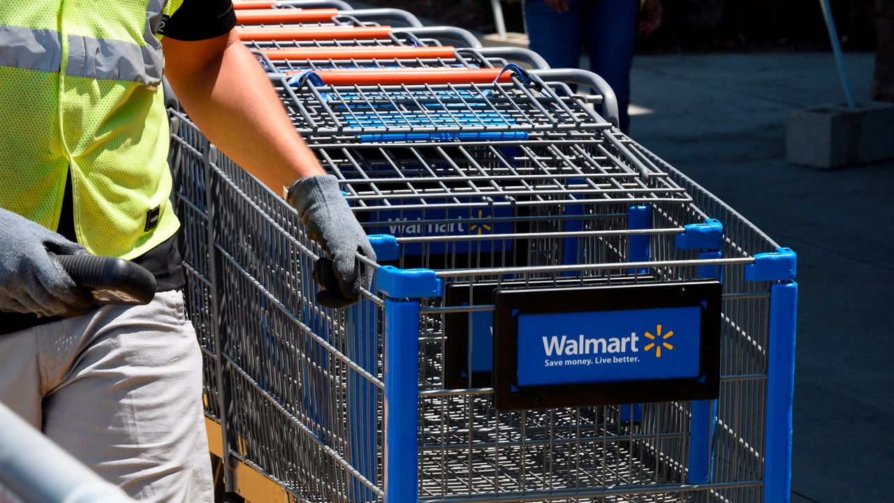 An employee gathers shopping carts at Walmart, July 22, 2020 in Burbank, California.