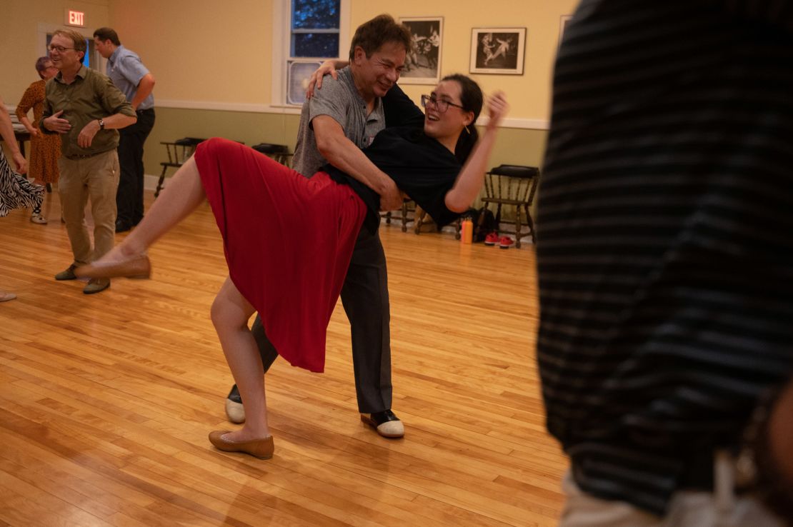 David Rose dances with Rhiannon Wiley at The Champlain Club. His regular dance partner is unable to attend because she's not vaccinated.