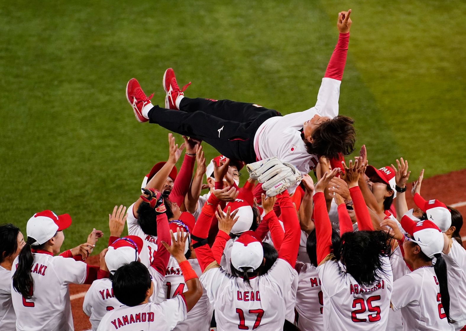 Japan's softball team celebrates with head coach Reika Utsugi after winning the gold-medal game against the United States on July 27. <a href="index.php?page=&url=https%3A%2F%2Fwww.cnn.com%2Fworld%2Flive-news%2Ftokyo-2020-olympics-07-27-21-spt%2Fh_13b9a6c62c003209afe550b465f7ab7e" target="_blank">Japan won 2-0.</a>