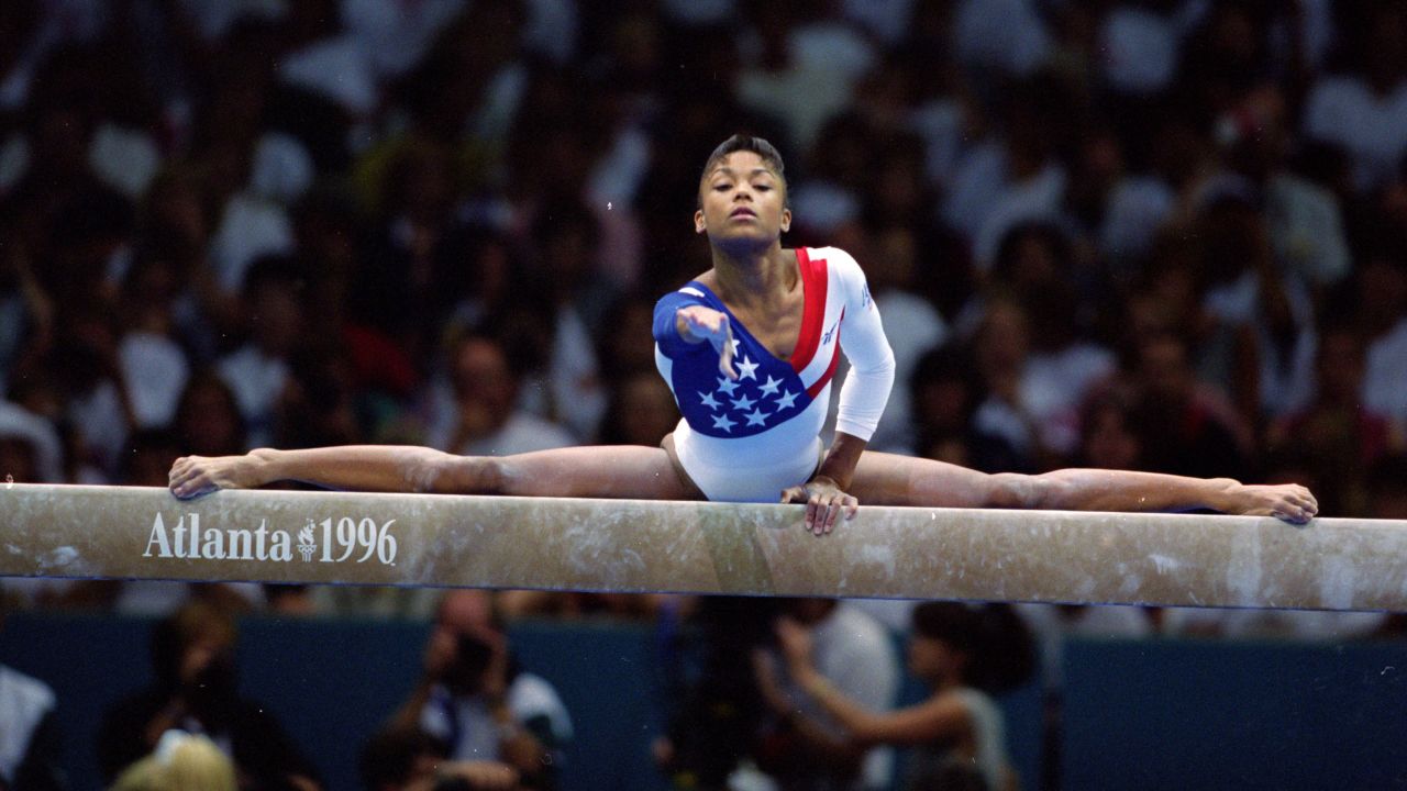 Dominique Dawes stretches on the balance beam at the 1996 Summer Olympics, in Atlanta, Georgia.