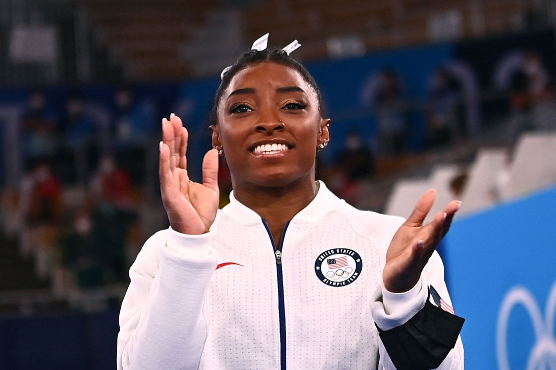 USA's Simone Biles applauds during the artistic gymnastics women's team final during the Tokyo 2020 Olympic Games at the Ariake Gymnastics Centre in Tokyo on July 27, 2021. (Photo by Loic VENANCE / AFP) 