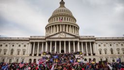 In this January 6, 2021, file photo, a large group of rioters stand on the east steps of the US Capitol after storming its grounds. 