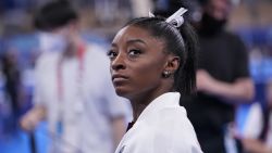 Simone Biles, of the United States, waits for her turn to perform during the artistic gymnastics women's final at the 2020 Summer Olympics, Tuesday, July 27, 2021, in Tokyo. (AP Photo/Gregory Bull)