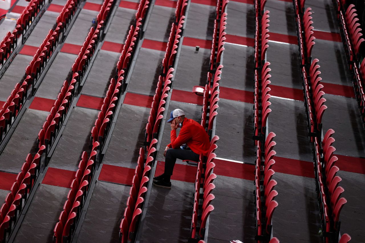 A man sits among rows of empty seats as he watches table tennis at the Tokyo Metropolitan Gymnasium on July 27.